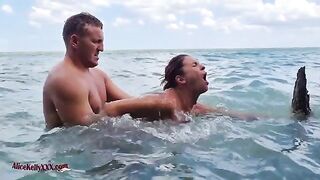 A couple enjoy sensual sex in the crystal clear waters of the blue lagoon