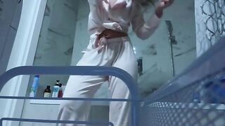 A petite girl caresses her sweet pussy in the bathroom, no one sees