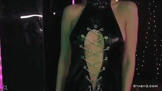 A skinny young girl named AngelQ takes off her clothes on stage