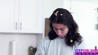 The guy is fucking his stepsister in the kitchen, exploring every angle