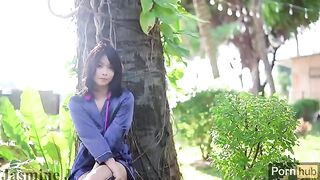 A cute Asian girl plays with a vibrator and dildo in the sunny garden