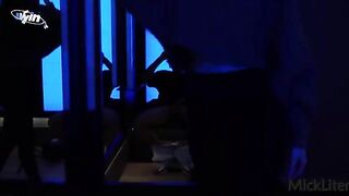 A girl is being tempted by a muscular man in the dressing room