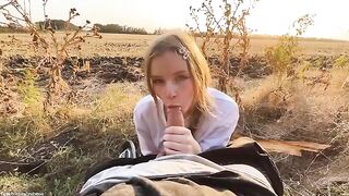 A beautiful Russian blonde makes a gentle blowjob at sunset in the forest