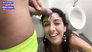 Brunette woman has sex in public toilet and receives a cumshot on her face