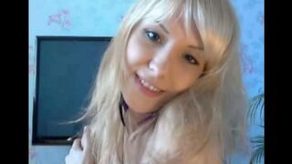 The blonde caresses her fingers with her pussy in a sensual solo performance