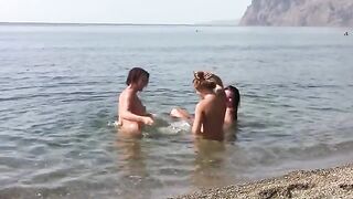 Three naked beauties on the coast, enjoying the sun and the sea