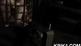 A mistress has a slave in a cage to fulfill all her orders