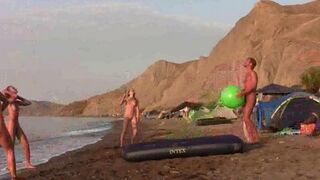 A girl is playing badminton naked on the nude beach
