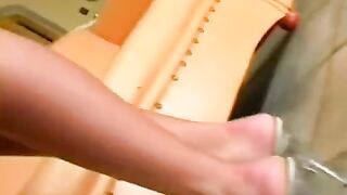 Beauty masturbates her pussy in a leather chair
