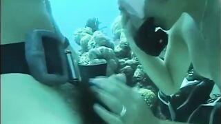 A guy has sex with a girl right in the water