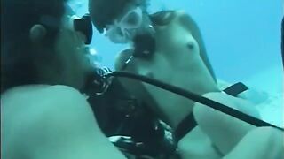 A guy has sex with a girl right in the water