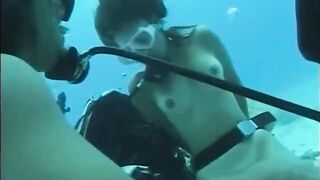 A guy has sex with a girl right in the water