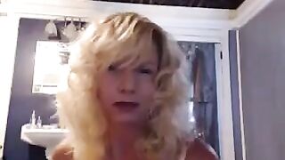 A aged woman has fun in the bathroom with a toy