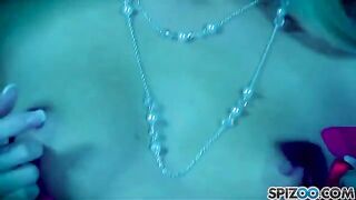 A blonde woman masturbating with a large dildo, exploring her body parts