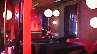 A black woman in a latex suit passionately rides her partner, showcasing intense energy