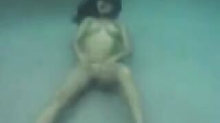 A busty brunette beauty enjoys sex right in the ocean