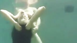 A busty brunette beauty enjoys sex right in the ocean