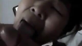 An old Chinese woman practices her blowjob skills on a young guy’s bed