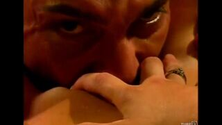 A couple enjoy each other with passion on the couch, creating a sensual scene