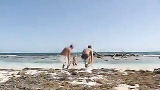 Beach threesome with a couple of cute girls in bikinis
