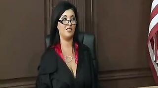 A woman in a power suit exudes dominance and raw sensuality