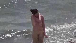 Nudist couple enjoy a romantic and relaxing time on the beach