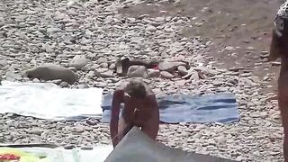 Nudist couple enjoy a romantic and relaxing time on the beach