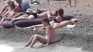 Nudist couple enjoy a romantic and relaxing time on the beach