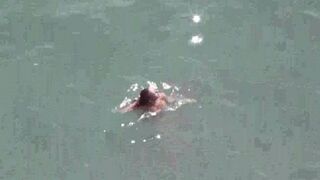 A naked couple enjoys each other on the sea