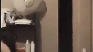 A hot guy admires his naked body in the mirror