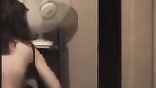 A hot guy admires his naked body in the mirror