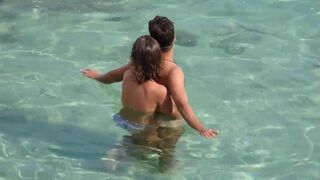 Girl fingers a guy’s cock underwater in a steamy sea scene