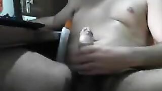A man sits in front of the computer and rubs his dick