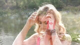 Blonde girl masturbates tenderly on the lake shore