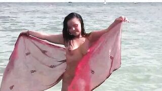 A naked girl is having bath in the sea