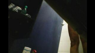 A hidden camera in the shower captures a girl's shaved pussy in steamy action
