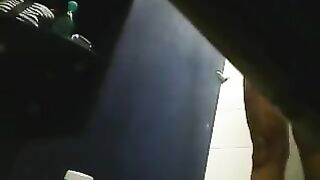 A hidden camera in the shower captures a girl's shaved pussy in steamy action