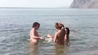 Nudists are having fun on the barefoot beach