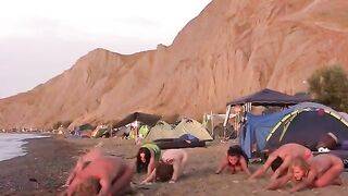A cheerful girl is having fun with friends on naked beach