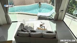 A lonely girl smokes and plays with her pussy in the pool
