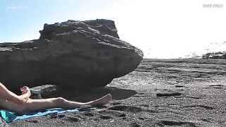 A girl undresses on the beach and plays with her body in front of a guy
