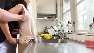 A mature woman with big tits is being fucked in the kitchen