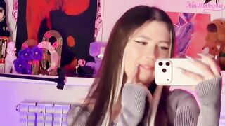 A girl plays with a big dildo in front of the mirror and showcases her exclusive video