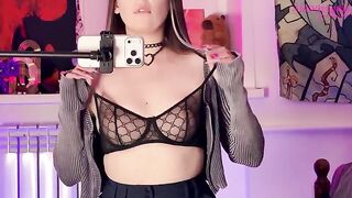 A girl plays with a big dildo in front of the mirror and showcases her exclusive video