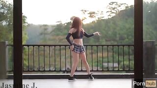 A cute Asian girl, Jasmine J, gets fucked by a machine on the balcony